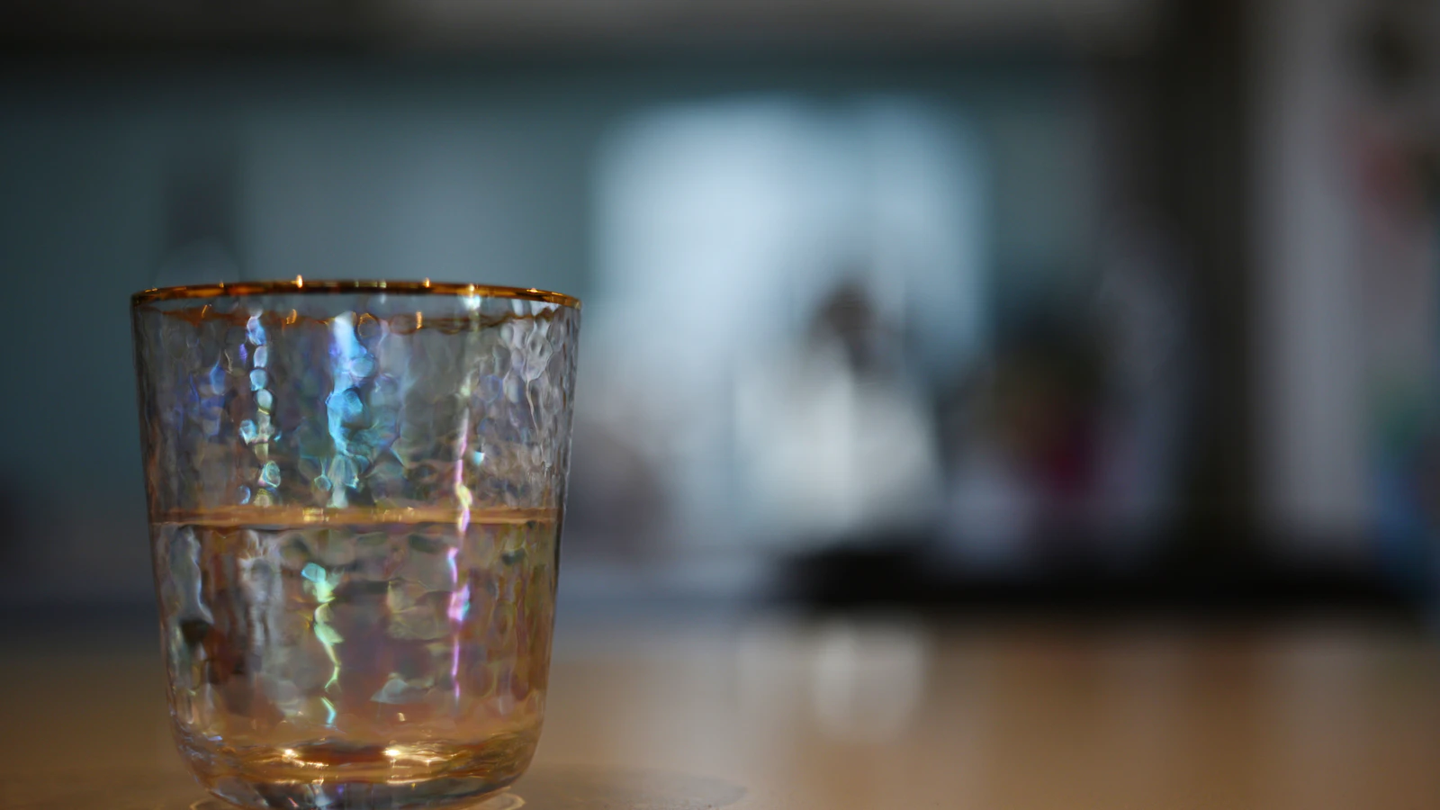 A glass of water on a table in a bright kitchen