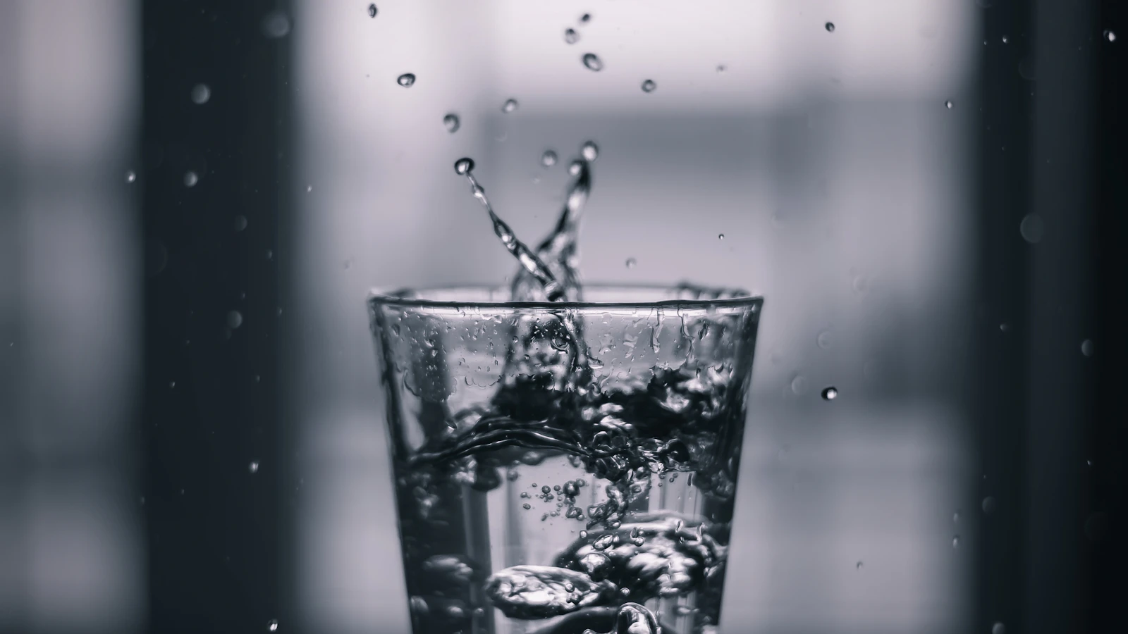 Close-up of water splashing into a glass